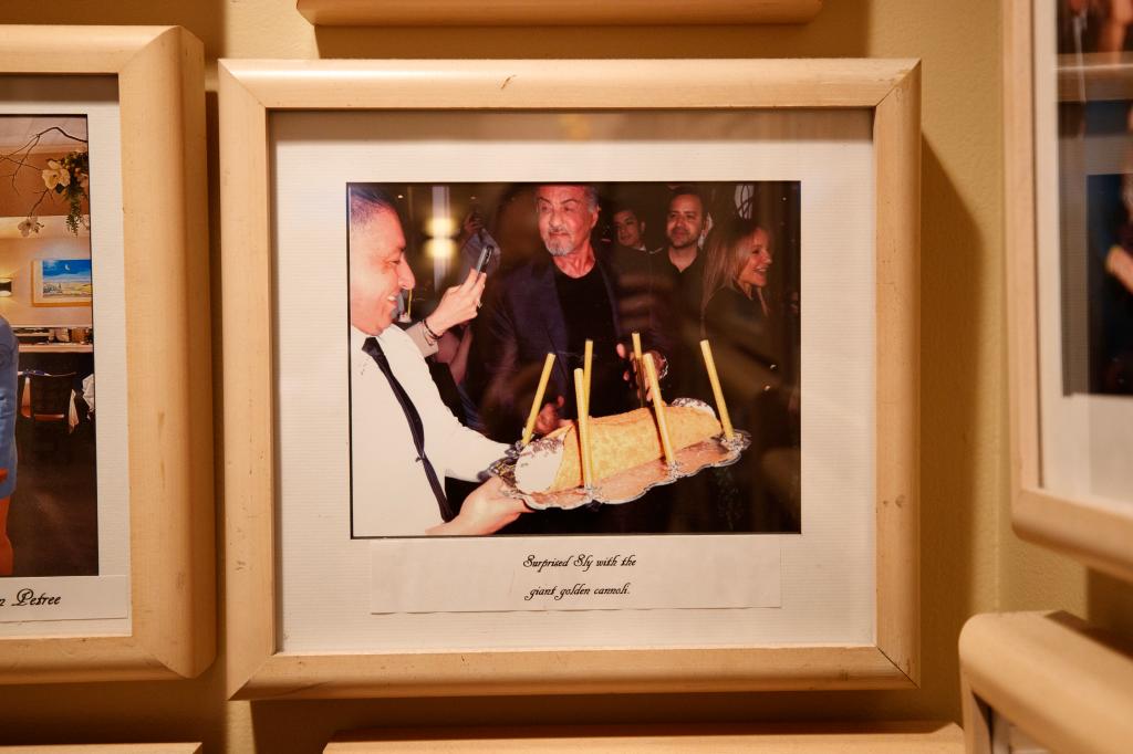 Sylvester Stallone with a giant cannoli at Fresco by Scotto.