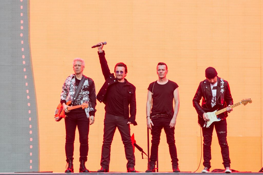 Bono, The Edge, Adam Clayton, and Larry Mullen Jr. on stage in London. 