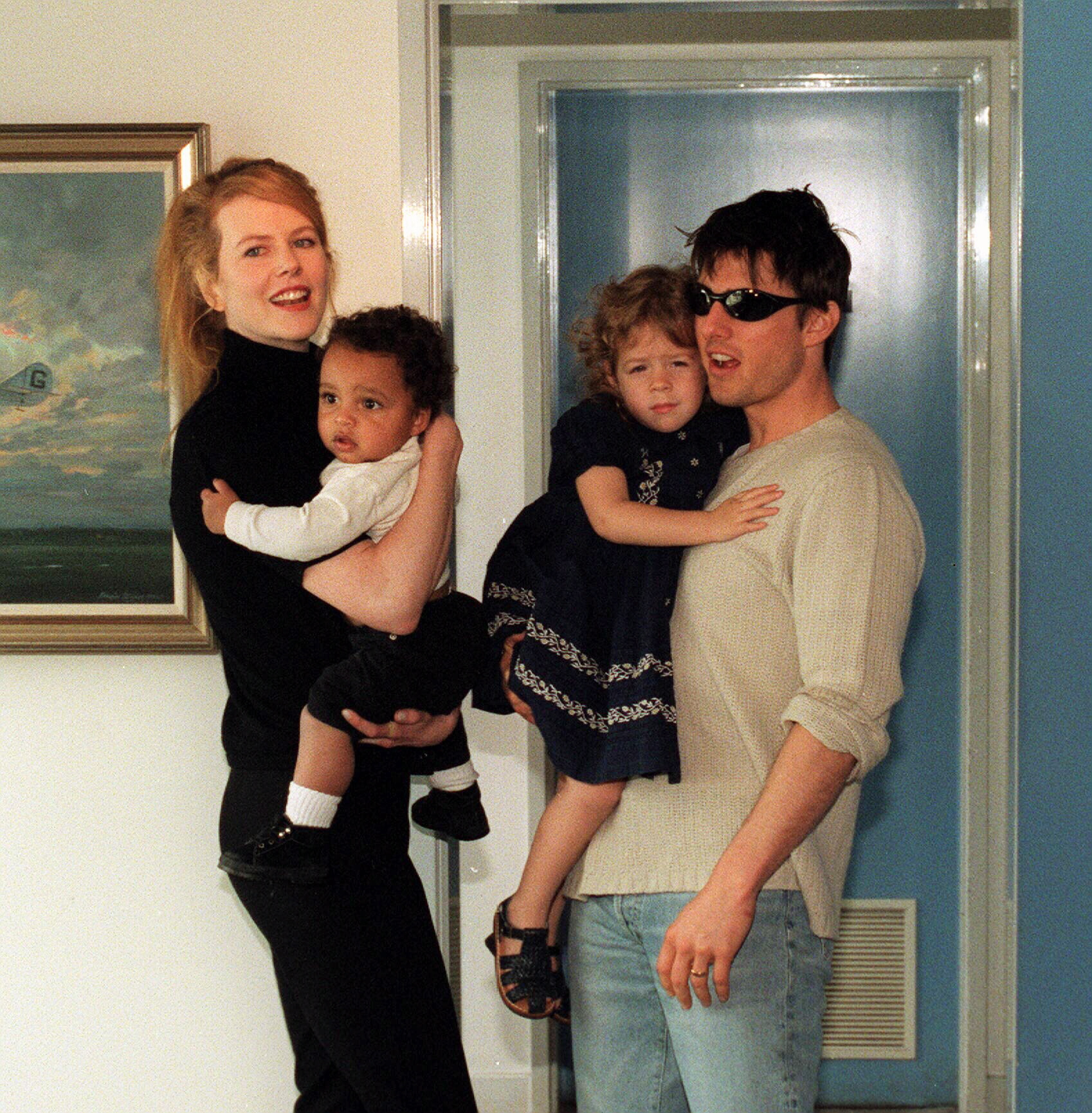 Nicole Kidman and Tom Cruise carrying kids Bella and Connor Cruise.