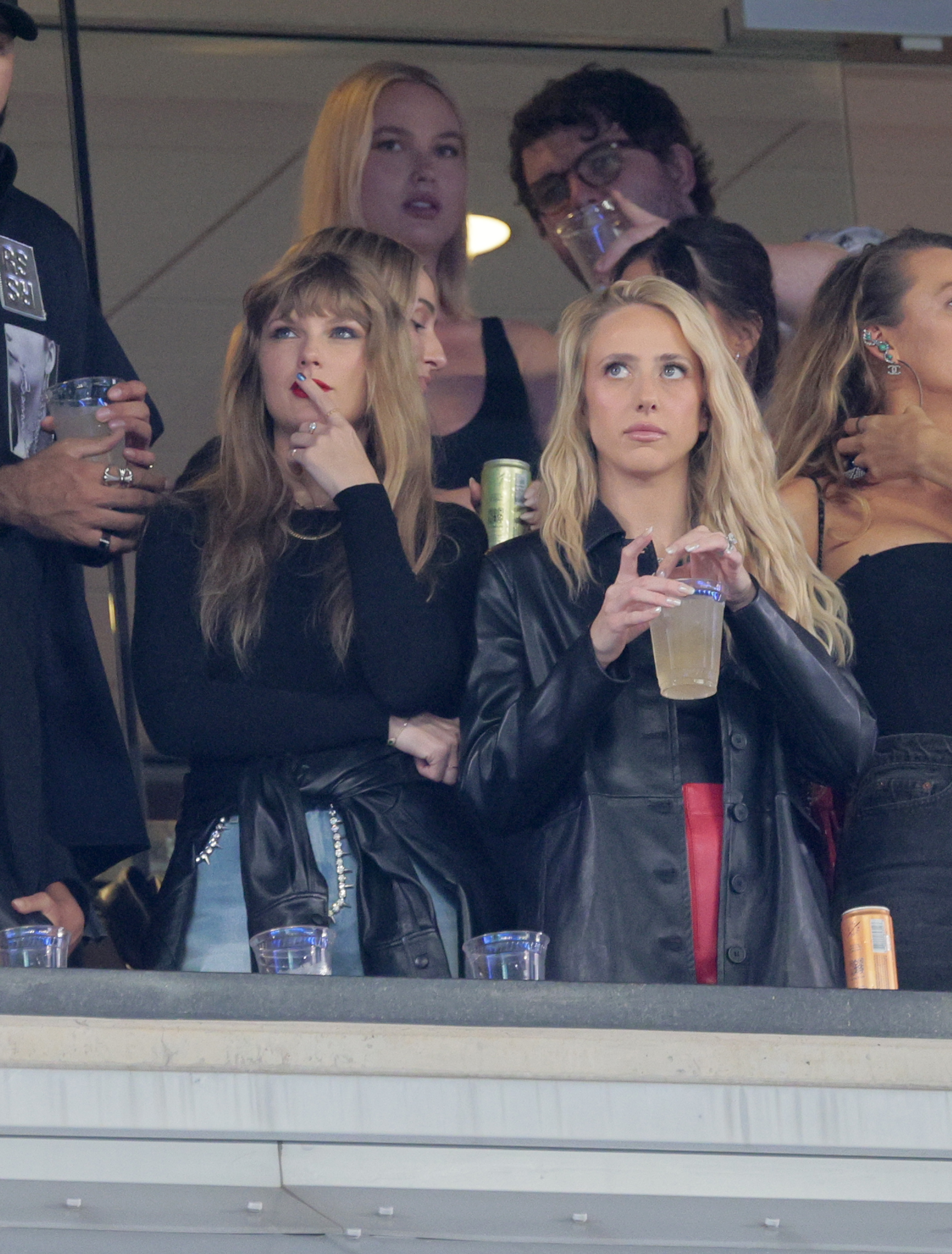 Artist Taylor Swift reacts along side Kansas City Chiefs quarterback Patrick Mahomes wife Brittany in a luxury box with a drink in her hand in the 2nd quarter.