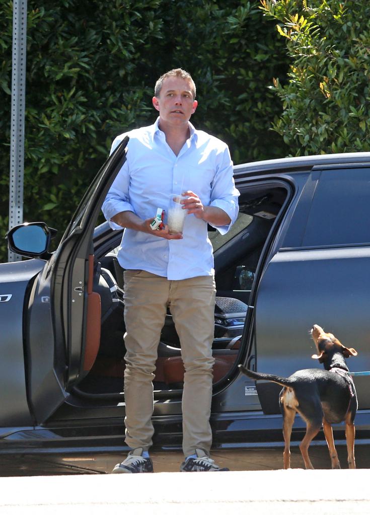 Ben Affleck standing outside of a car