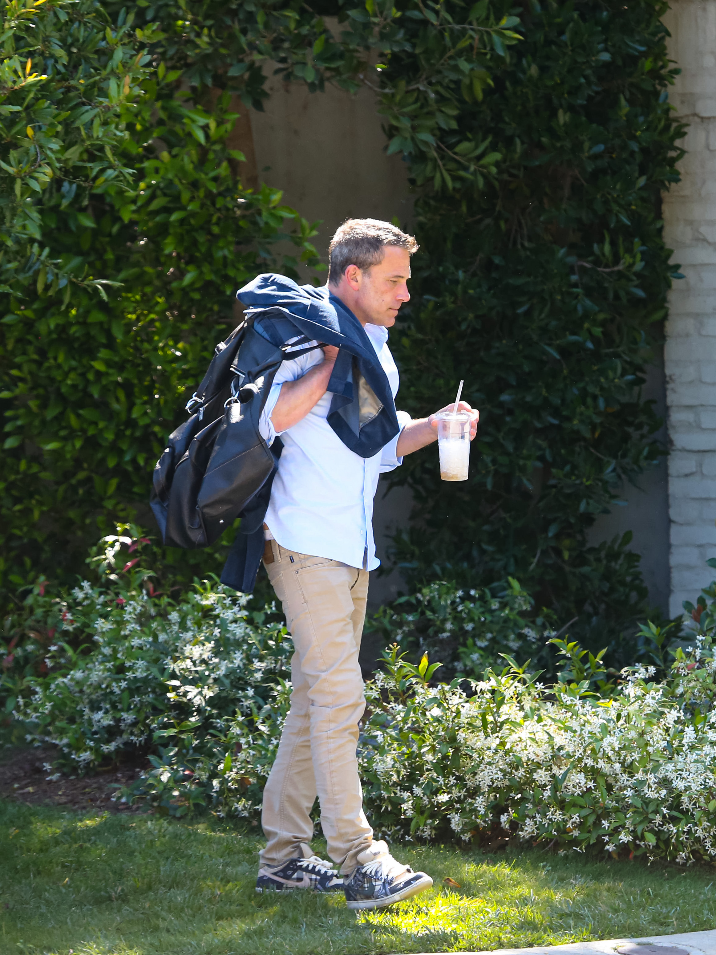Ben Affleck walking with a duffel bag