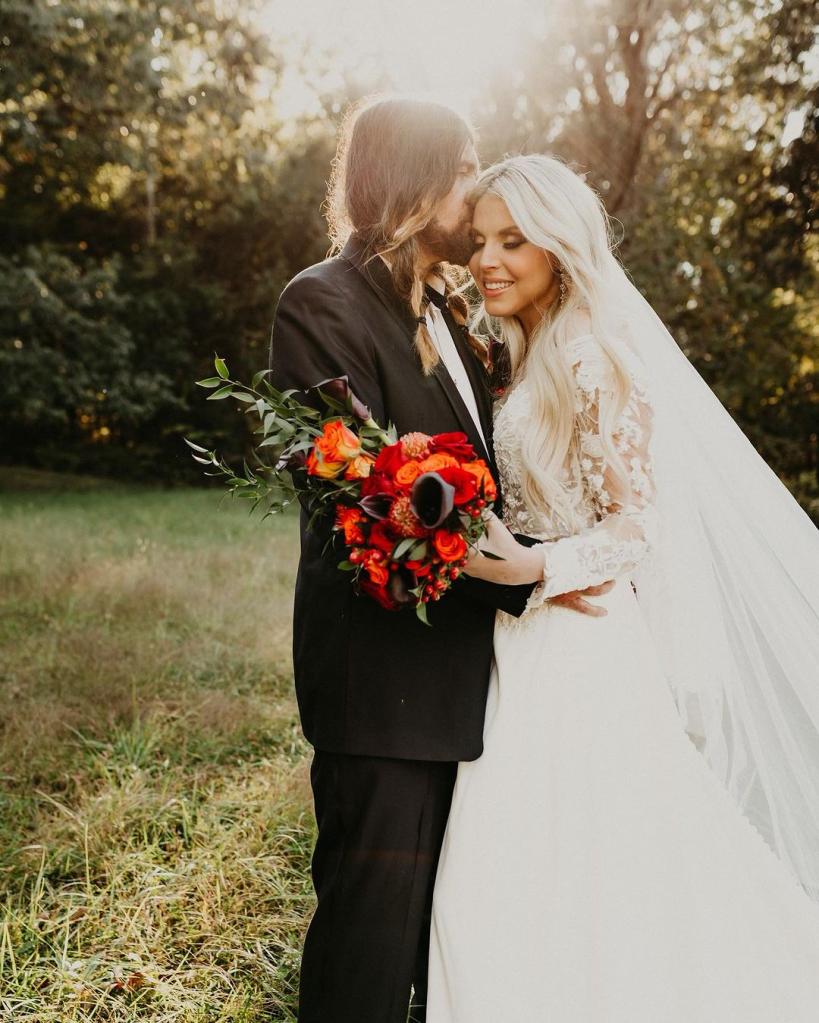 Billy Ray Cyrus kisses his wife Firerose Cyrus in a wedding photo