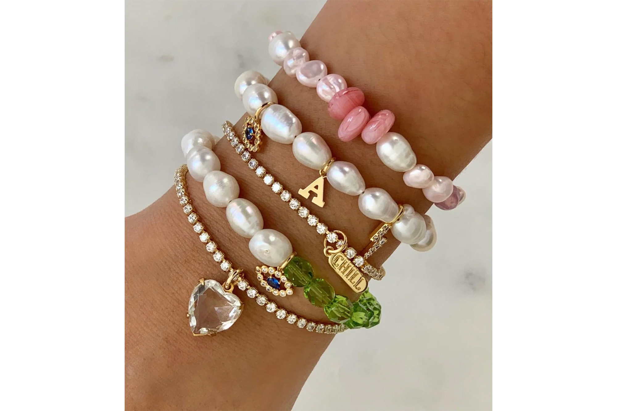 An arm with a stack of bracelets on it