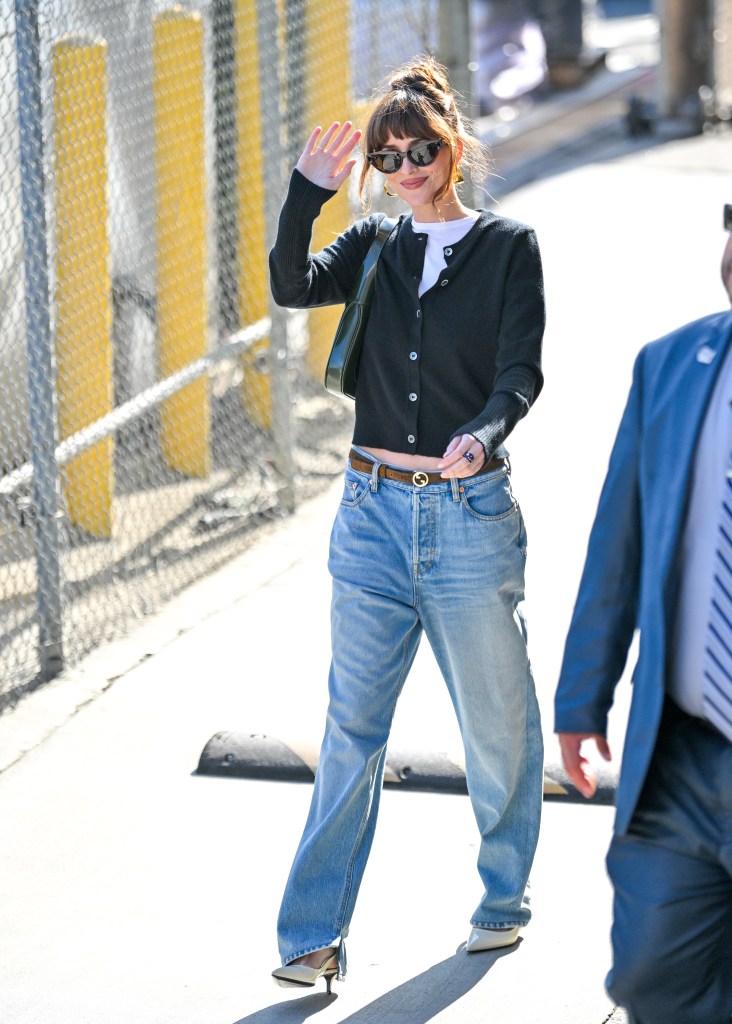 Dakota Johnson leaving Jimmy Kimmel Live wearing a cardigan and jeans