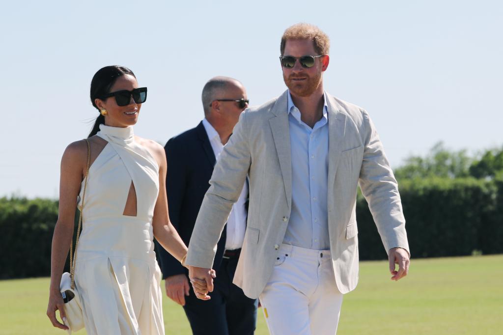 Meghan Markle and Prince Harry holding hands. 