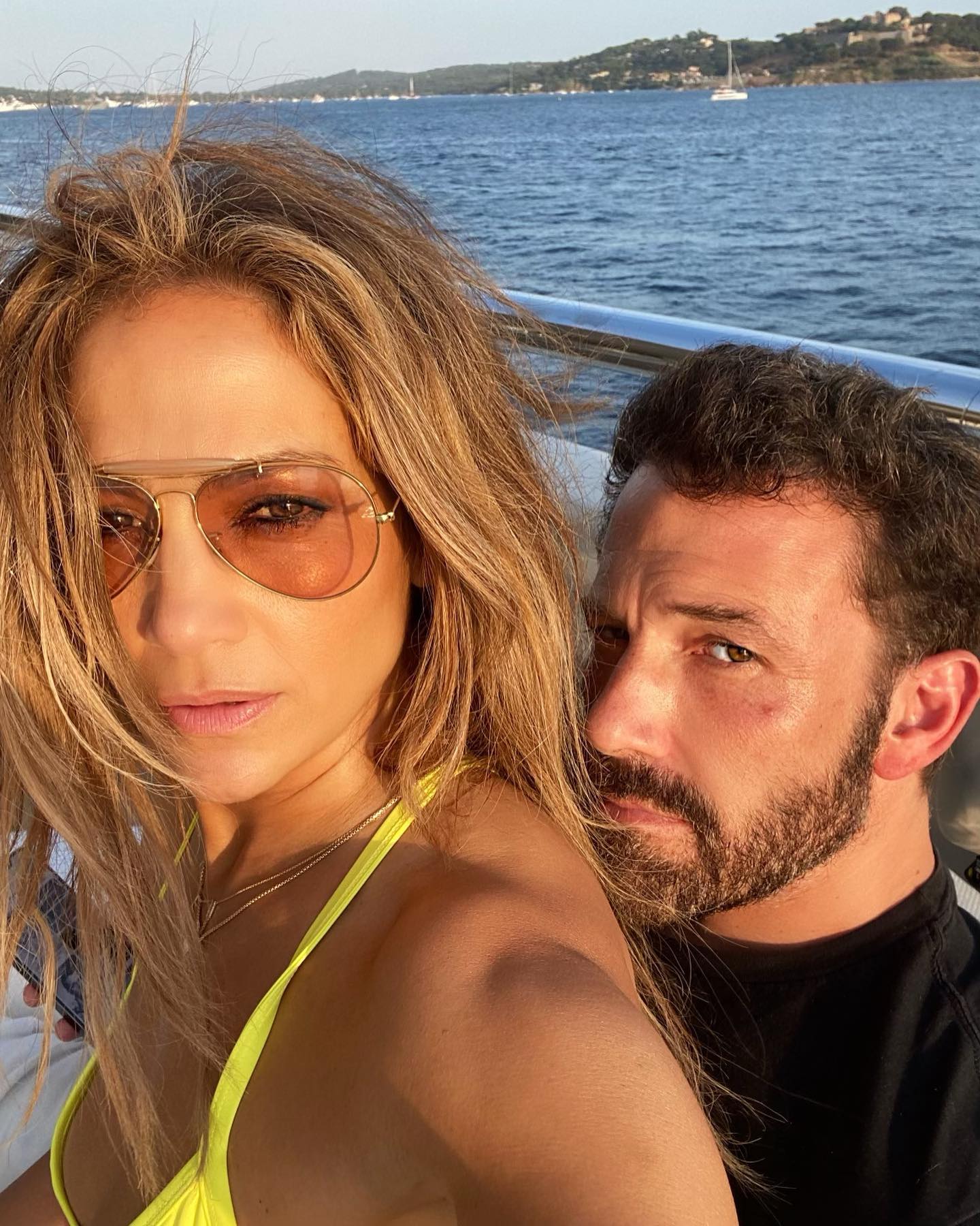 Jennifer Lopez and Ben Affleck take a selfie on a boat.