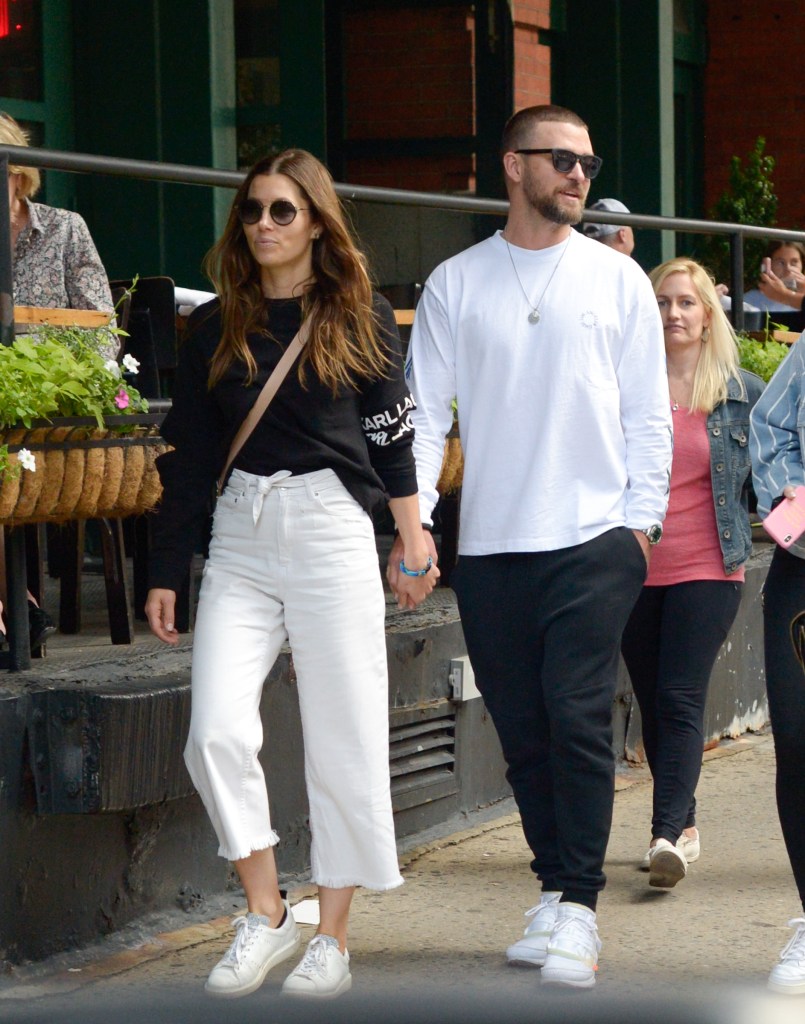 Justin Timberlake and Jessica Biel holding hands. 