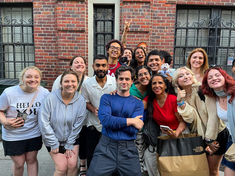 Penn Badgley poses with fans on the set of 'You'