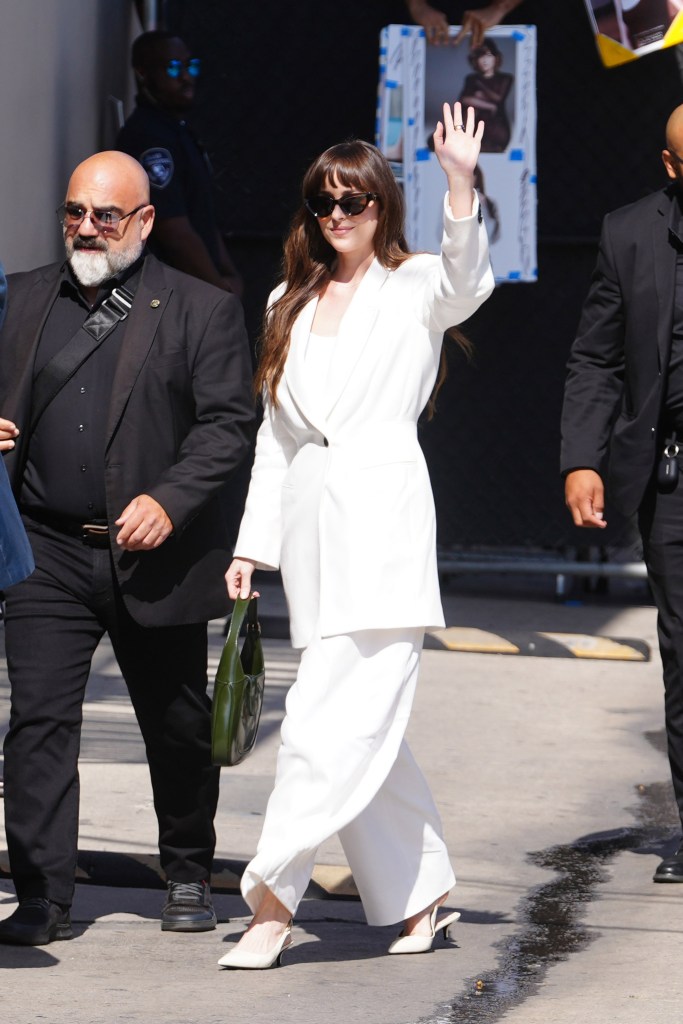 Dakota Johnson arriving at Jimmy Kimmel Live wearing a white suit