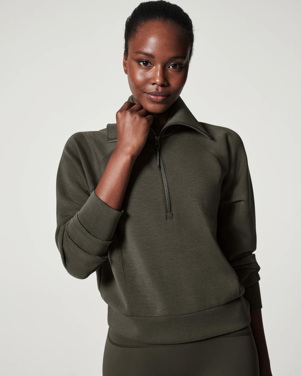A model in a half zip sweatshirt