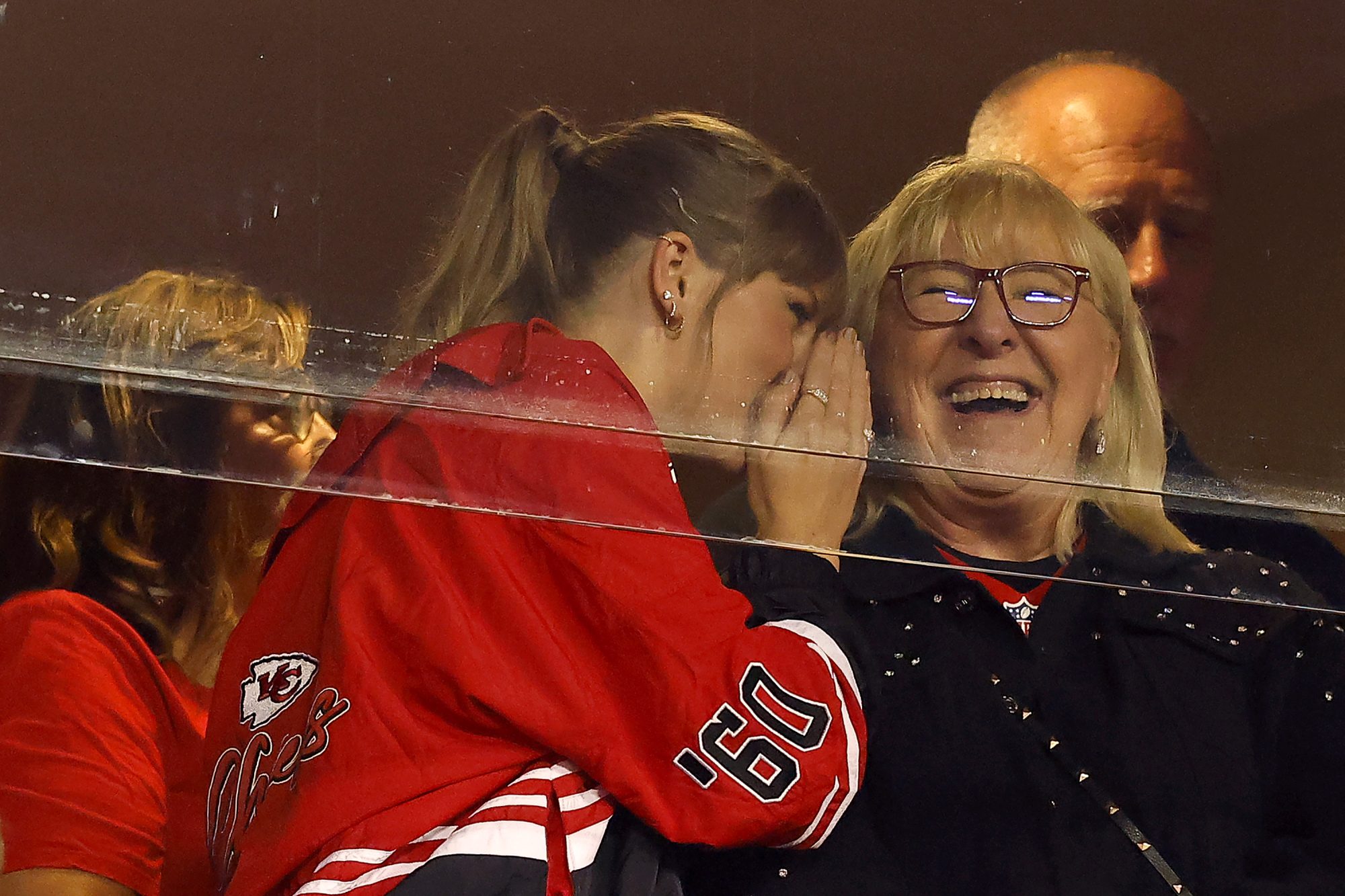 Taylor Swift whispers in Donna Kelce's ear at the Chiefs game.