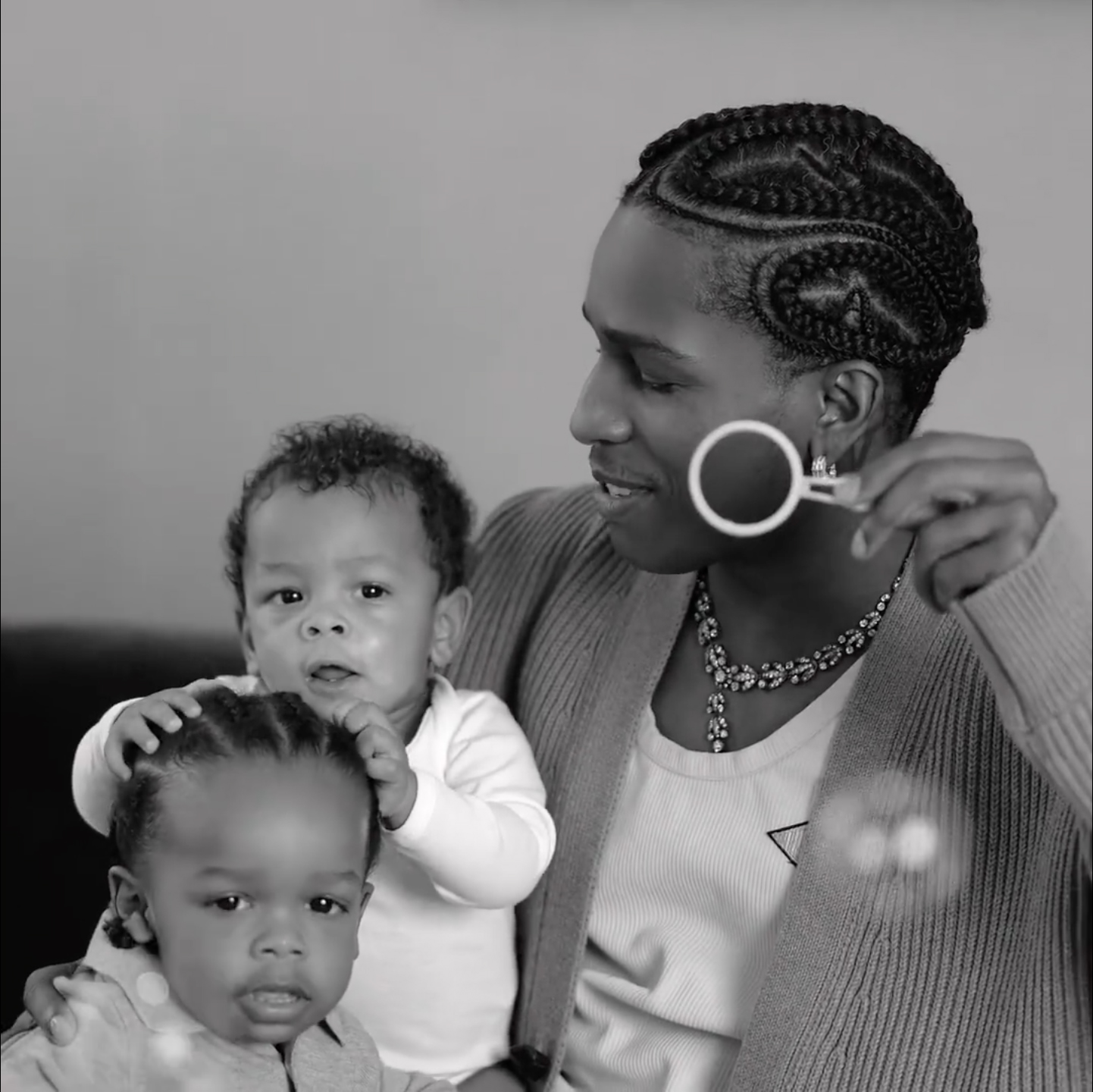 A$AP Rocky blowing bubbles with his sons, Riot and RZA.
