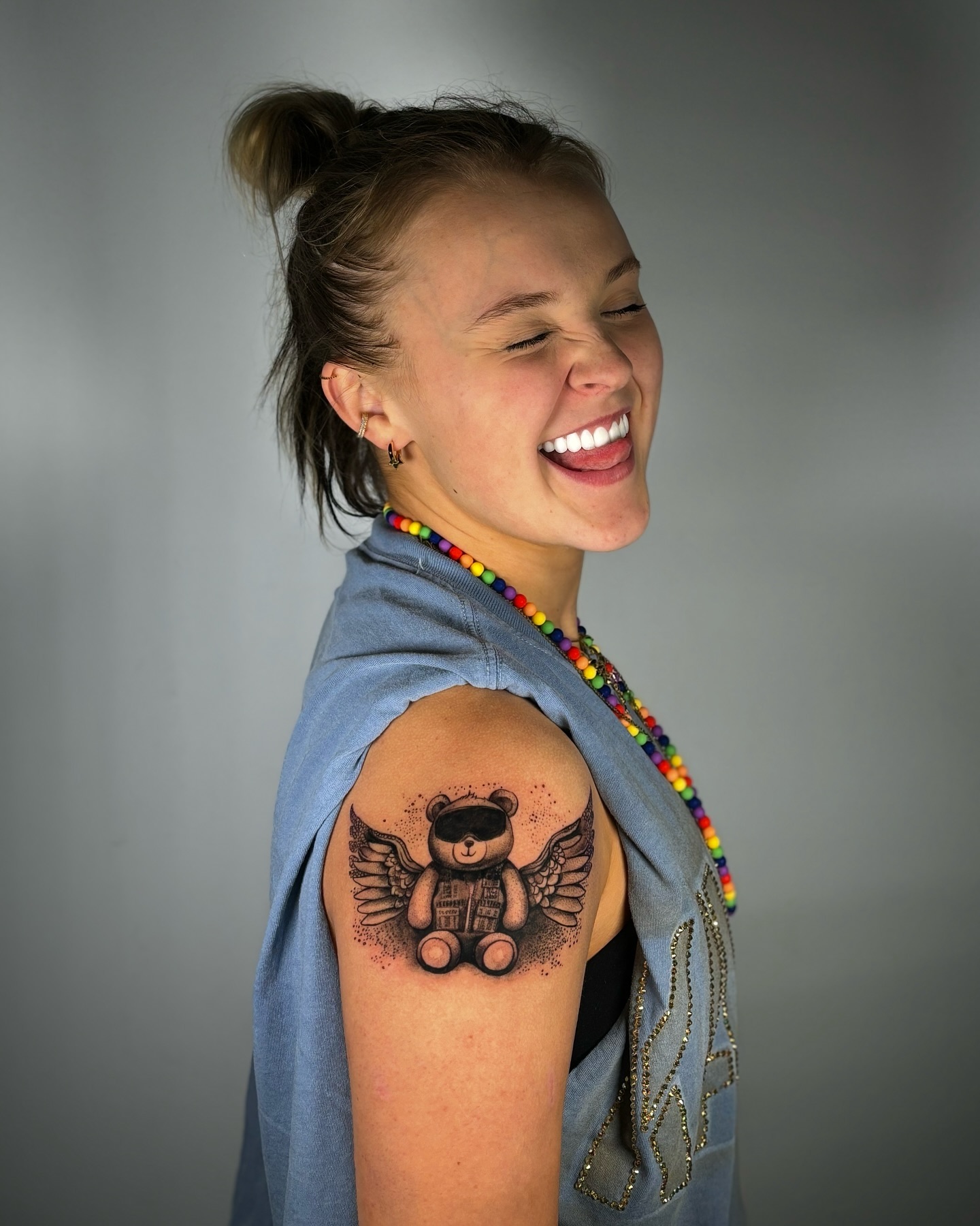 jojo siwa with a winged teddy bear tattoo on her arm