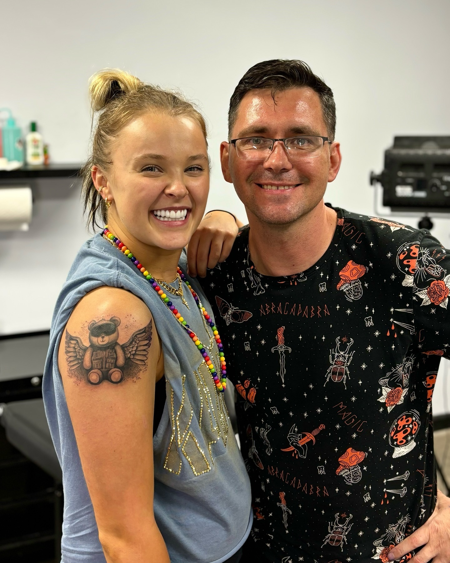 jojo siwa posing with her male tattoo artist