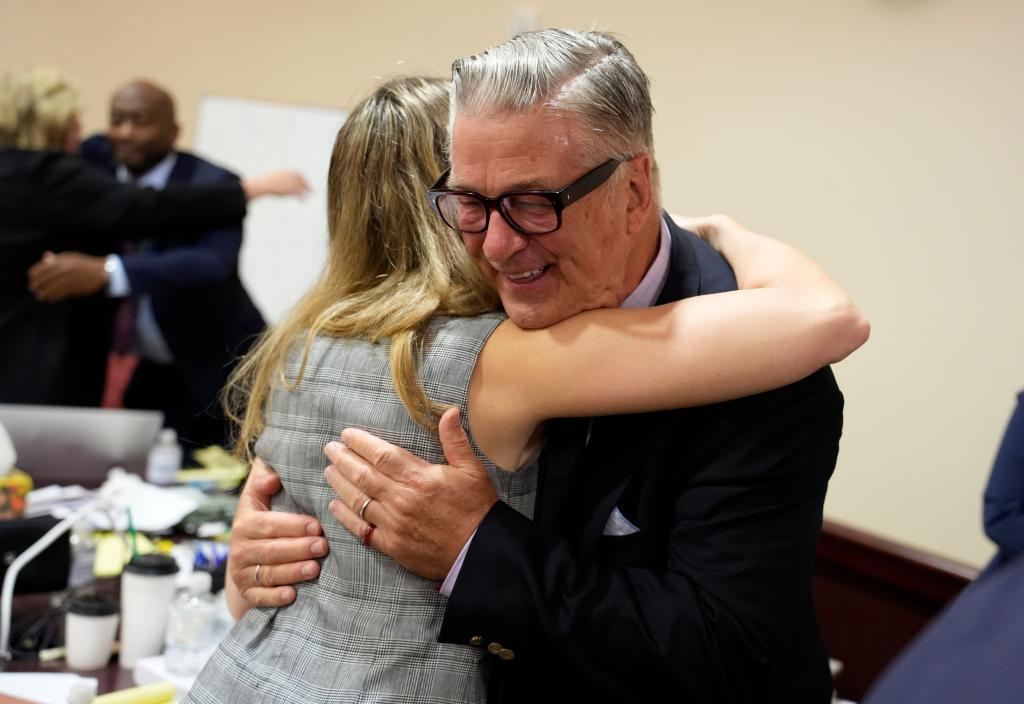 Alec Baldwin hugging legal team