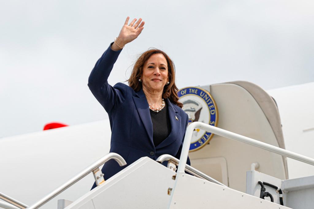 Kamala Harris waving to fans.