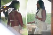 Kim Kardashian wore a silky white halter top and matching skirt to Michael Rubin’s Fourth of July party in the Hamptons on Thursday.