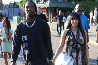 Cardi B totes comically large Chanel purse at Disneyland Paris with Offset and kids