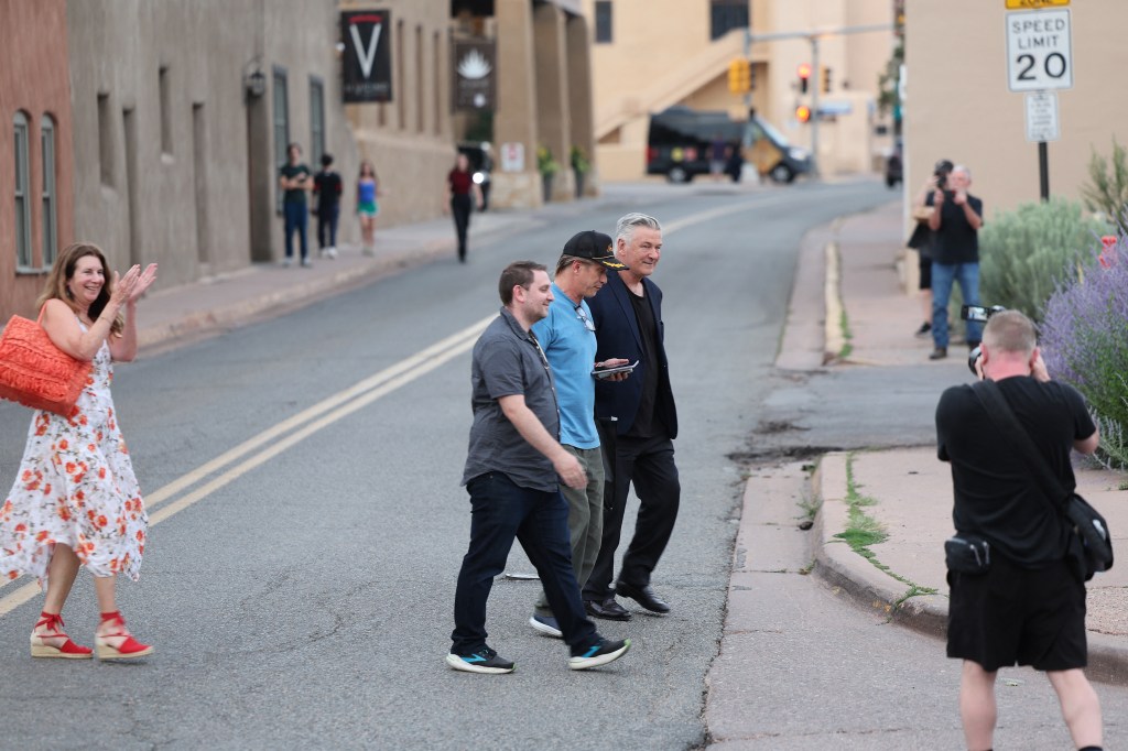 Alec Baldwin walking with legal team