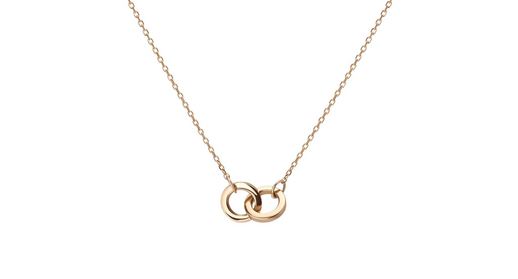 A gold necklace with an interlocking pendant