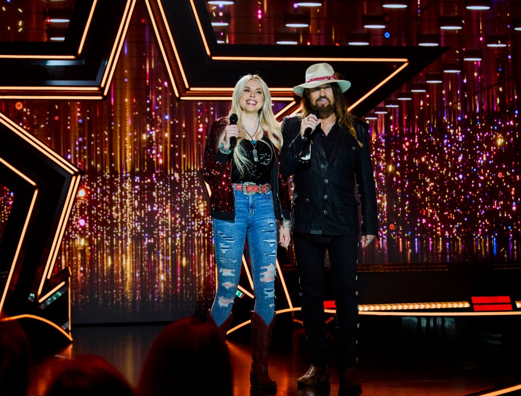 Firerose Cyrus and Billy Ray Cyrus on stage together.