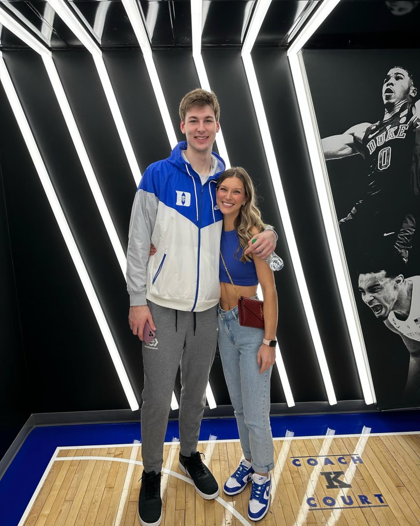 Kyle Filipowski and Caitlin Hutchinson wearing Duke University colors. 