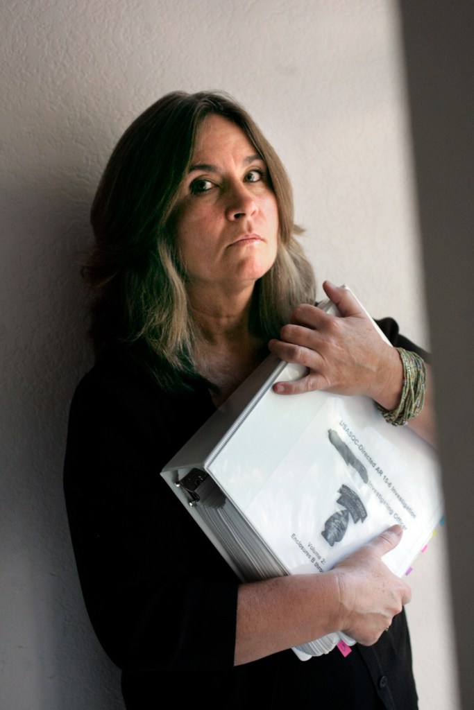 Mary Tillman holding government papers concerning her son.