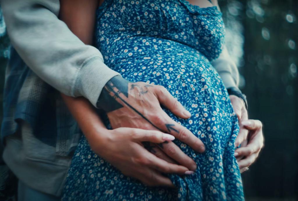 MGK cradled Fox's stomach in Friday's "Lonely Road" music video.