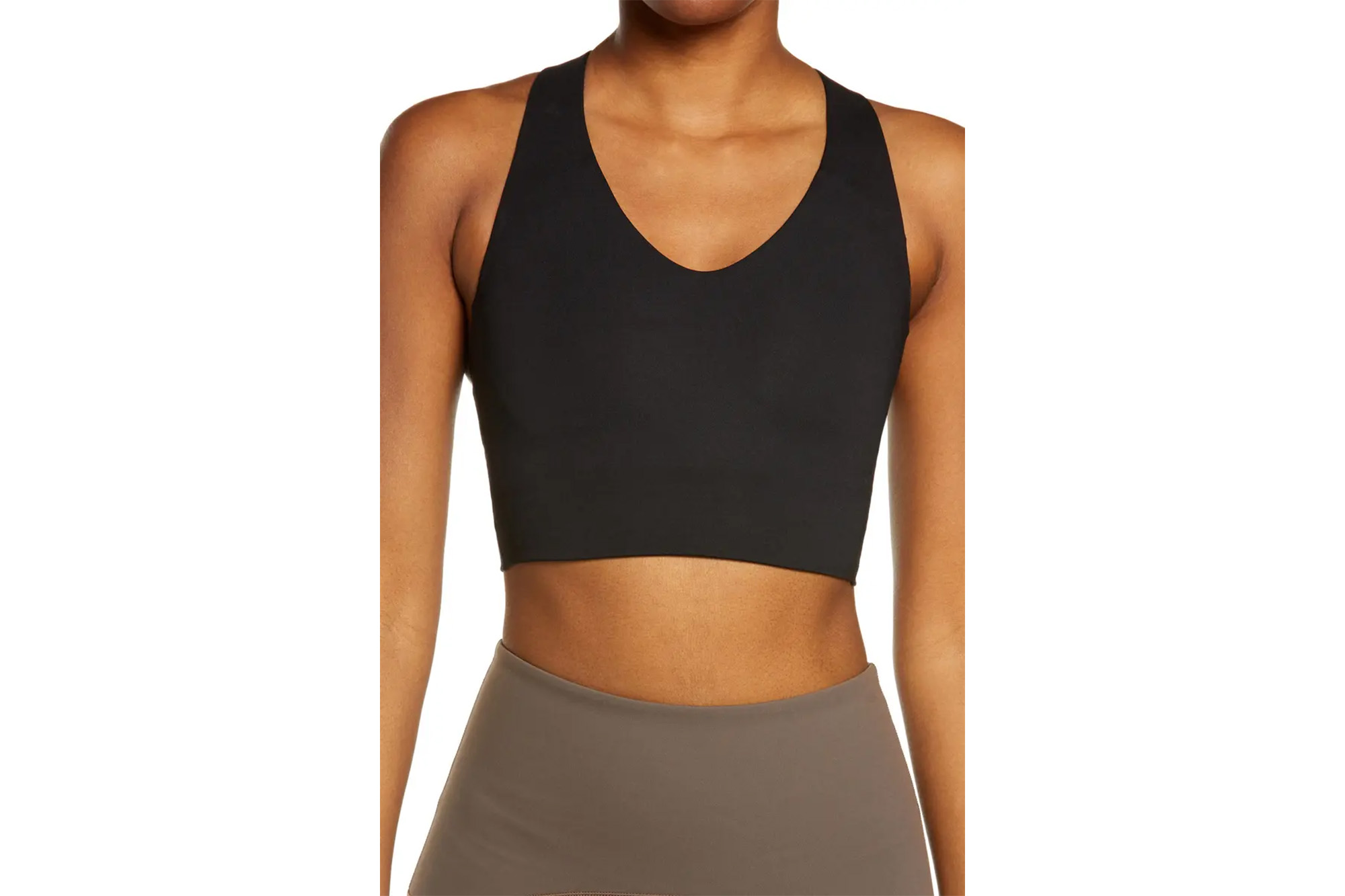 A model in a longline Spanx sports bra