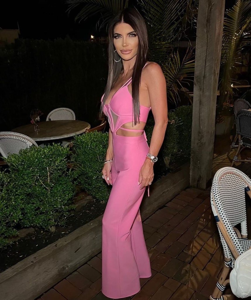 Teresa Giudice posing in a pink jumpsuit.