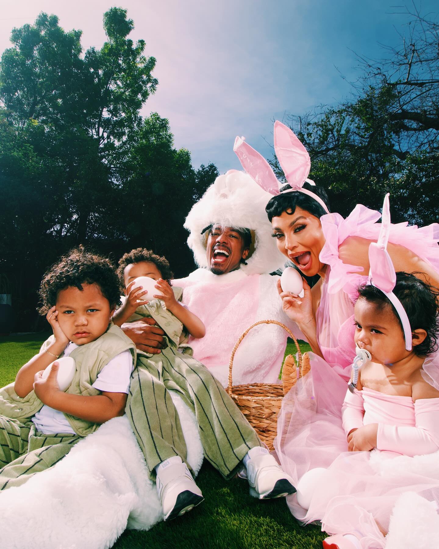 nick cannon dressed as the easter bunny with some of his kids