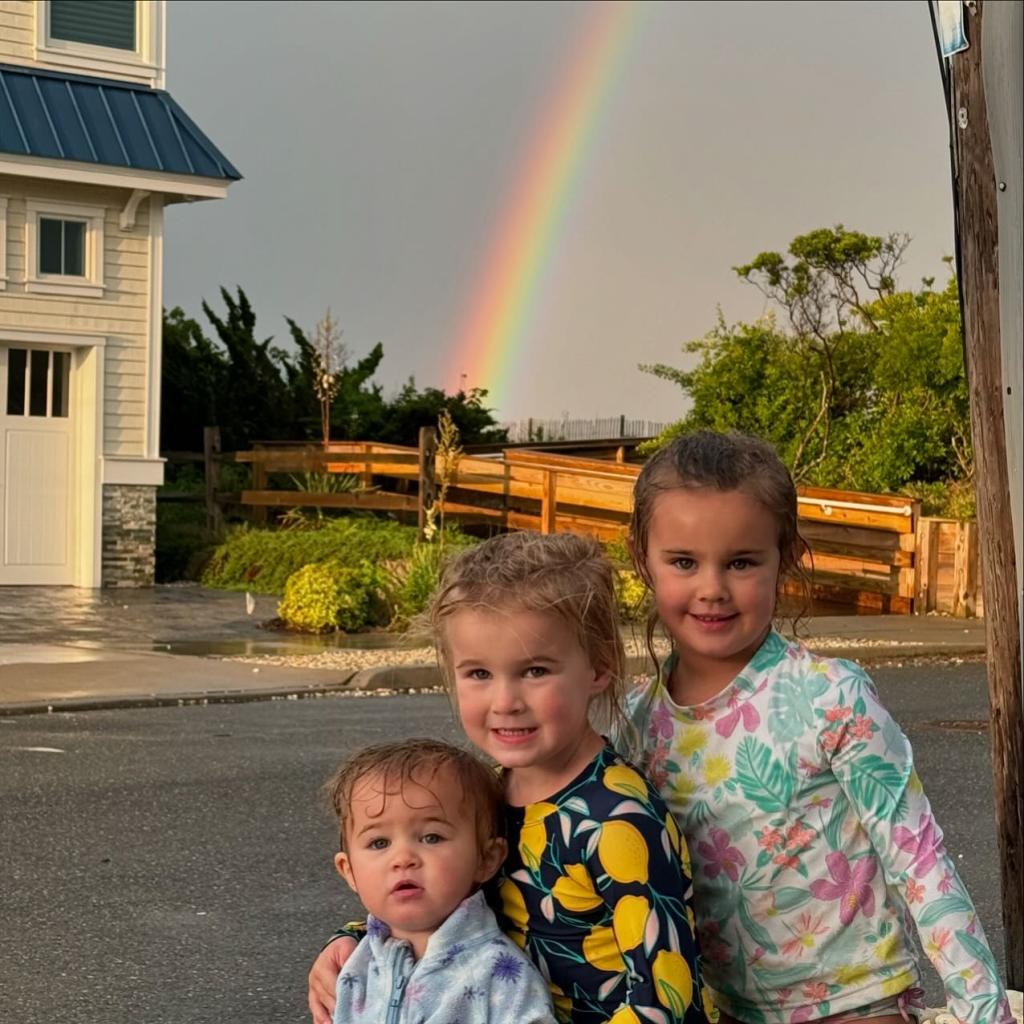 Kylie Kelce and Jason Kelce's children in front of a rainbow.