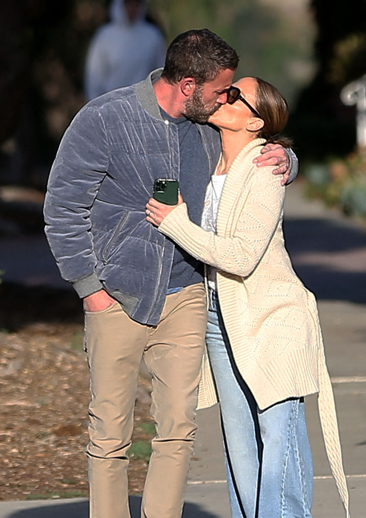 Ben Affleck and Jennifer Lopez share a kiss while out for a morning walk in November.