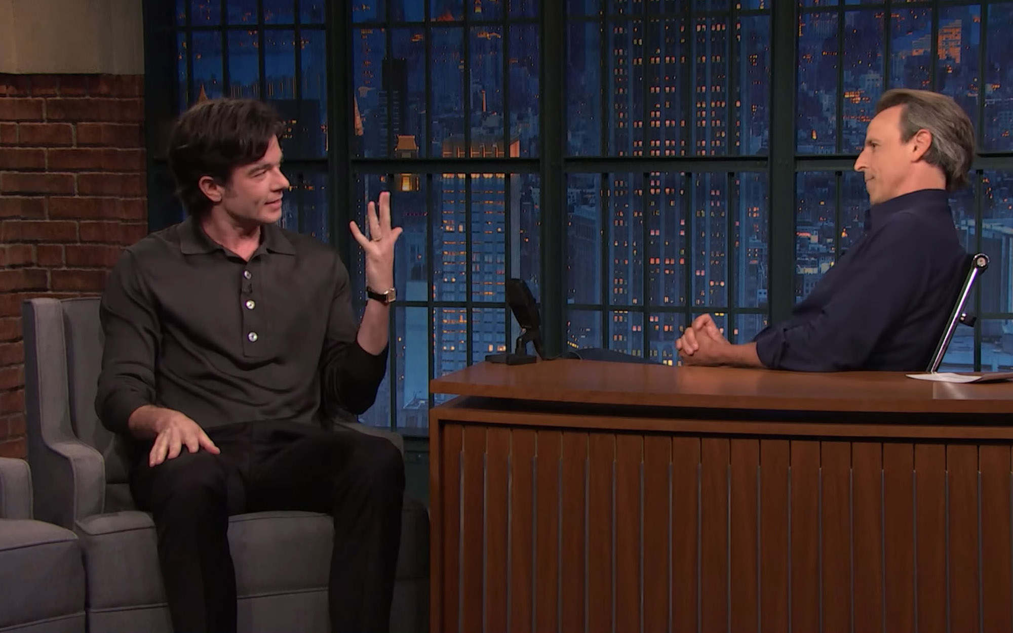 john mulaney showing his wedding ring to seth meyers