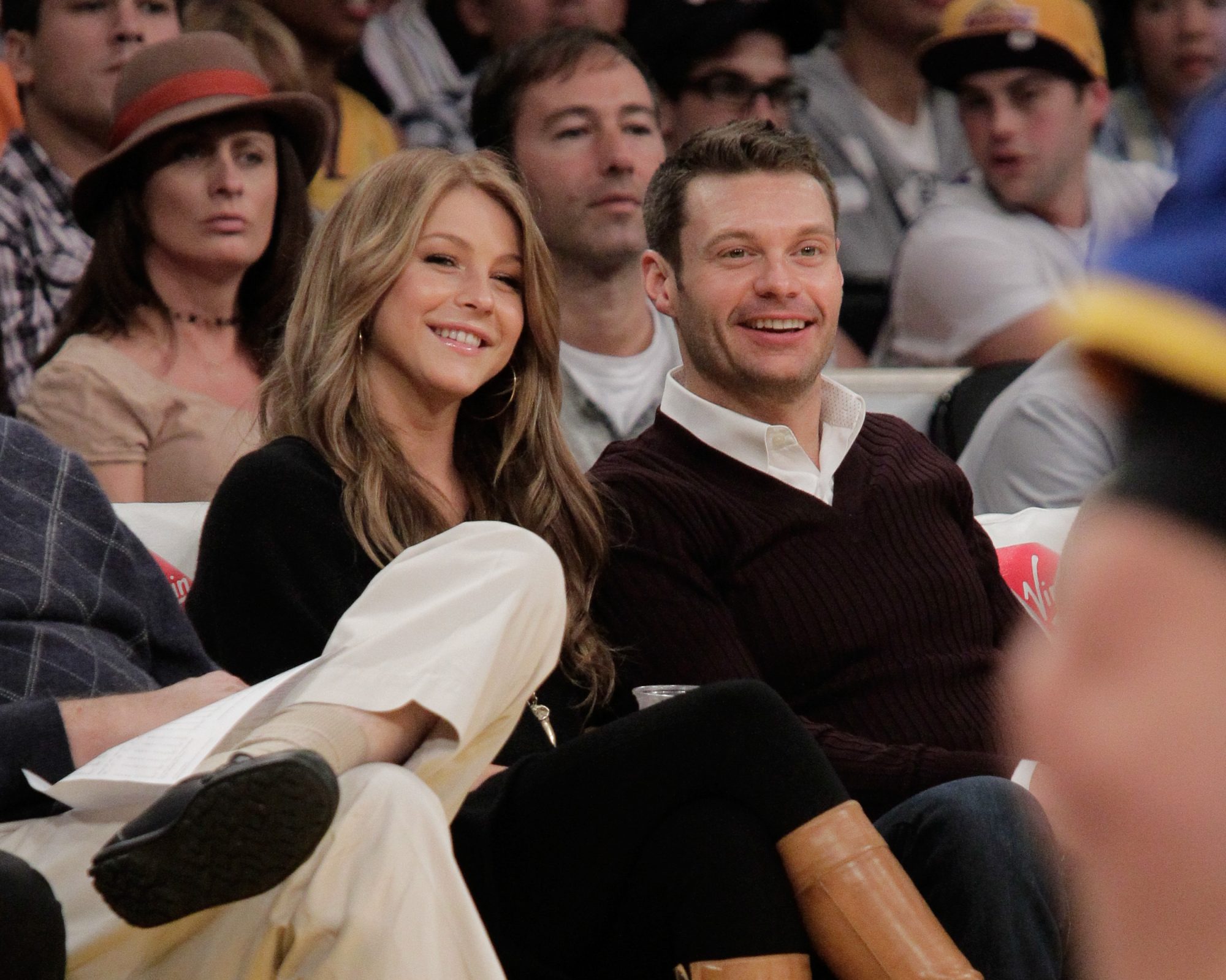 Julianne Hough and Ryan Seacrest sit courtside at a game between Golden State Warriors and the Los Angeles Lakers in 2010.