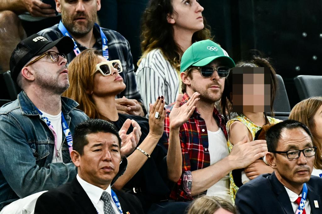 Eva Mendes (C-L) and her partner Canadian actor Ryan Gosling (C-R) attend the artistic gymnastics women's uneven bars final during the Paris 2024 Olympic Games.