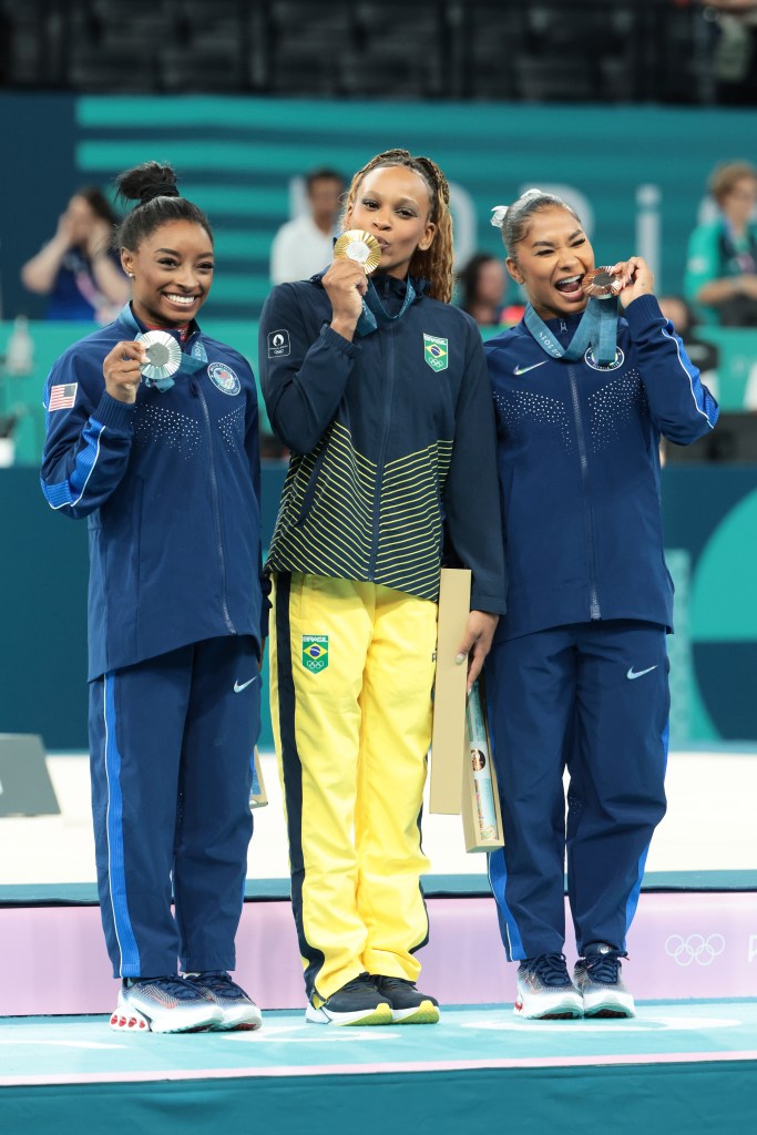 Gold medalist Rebeca Andrade (C) of Team Brazil, silver medalist Simone Biles (L) of Team United States and bronze medalist Jordan Chiles (R) of Team United States pose on the podium at the Artistic Gymnastics Women's Floor Exercise Medal Ceremony on day ten of the Olympic Games Paris 2024.