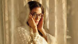 Angelina Jolie in a still from the movie, wearing glasses and a jumper