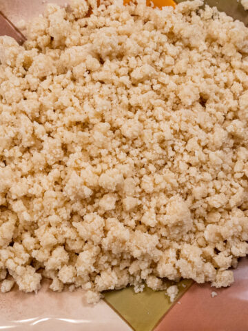 Crumb topping on a multi-colored plate.