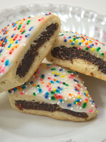 A plate of Cuccidati, fig and nut filled Italian Cookies sprinkled with multi-colored nonpariels.