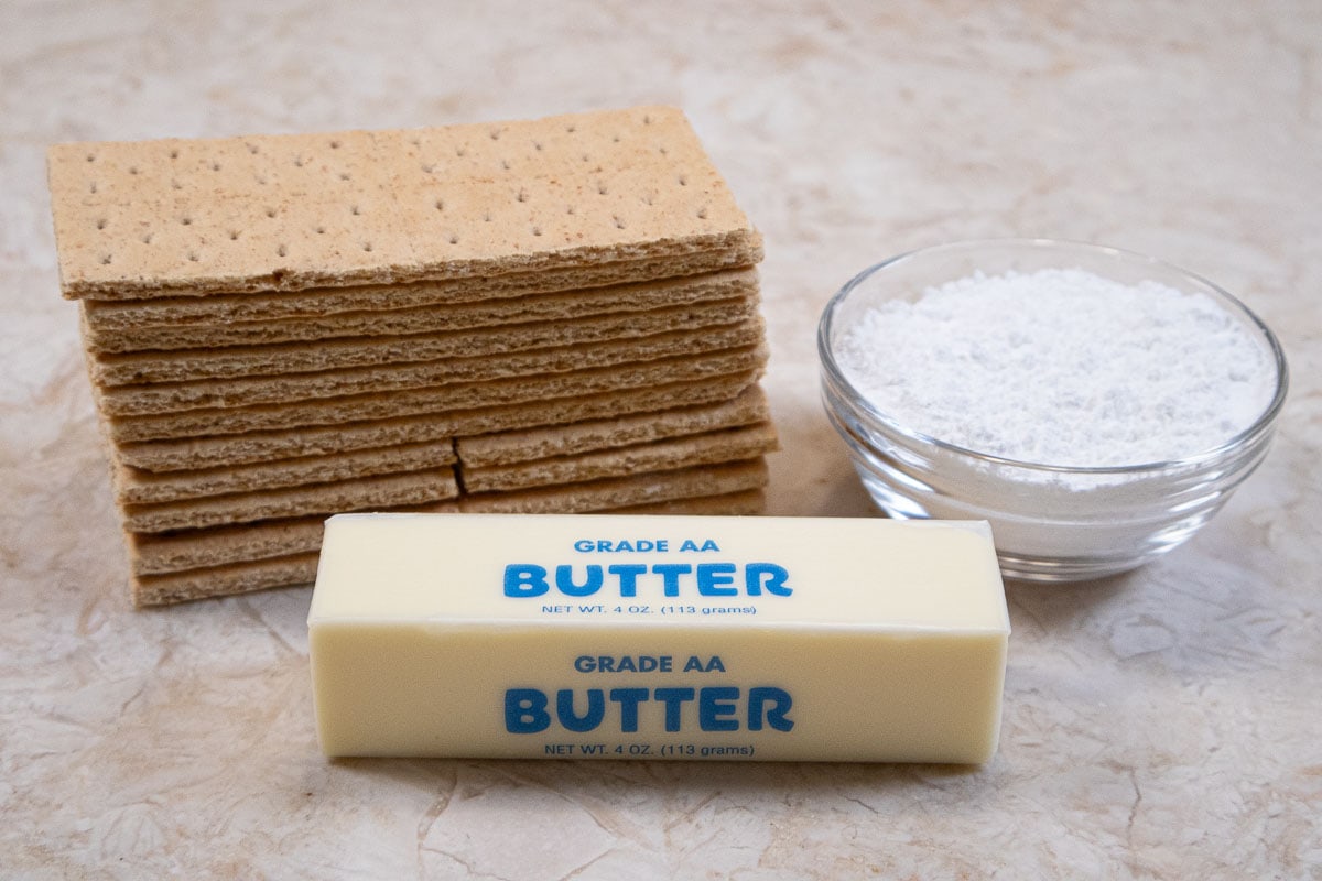 The ingredients for the graham cracker crust are graham crackers, powdered sugar and butter.