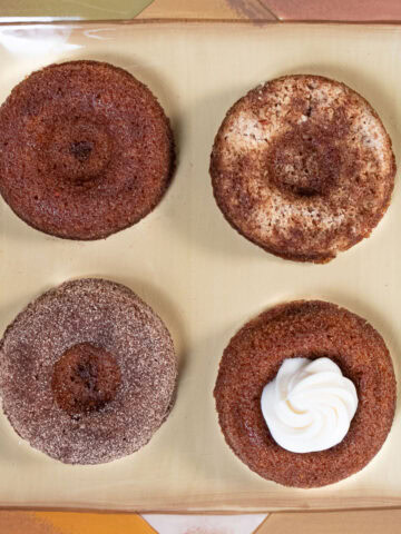 Four finishes on the Carrot Cake Dougnuts are plain, pecan topped, sugared and filled with cream cheese.