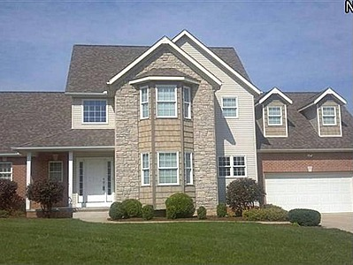 North Canton Home Features Stone Fireplace, Vaulted Ceilings