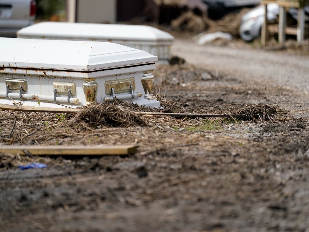 Caskets that floated from their tombs during flooding from Hurricane Ida sit along a roadside in Ironton, Louisiana, on Sept. 27.