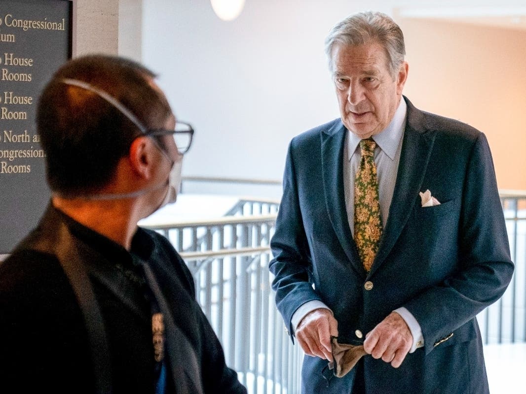 Paul Pelosi, right, the husband of House Speaker Nancy Pelosi, of California, follows his wife as she arrives for her weekly news conference on Capitol Hill in Washington on March 17, 2022.