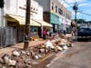 Debris from flood damage is piled up in front of Goldberg's Famous Deli and other businesses in Millburn, N.J., Saturday, Sept. 4.