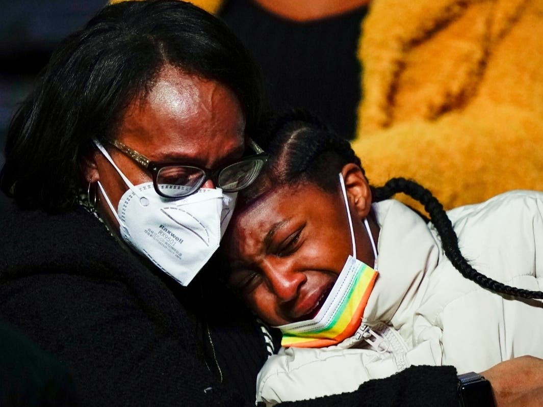 Mourners embrace during funeral services Monday at Temple University for the victims of a deadly row house fire in Philadelphia. Officials said it was the city's deadliest single fire in at least a century.