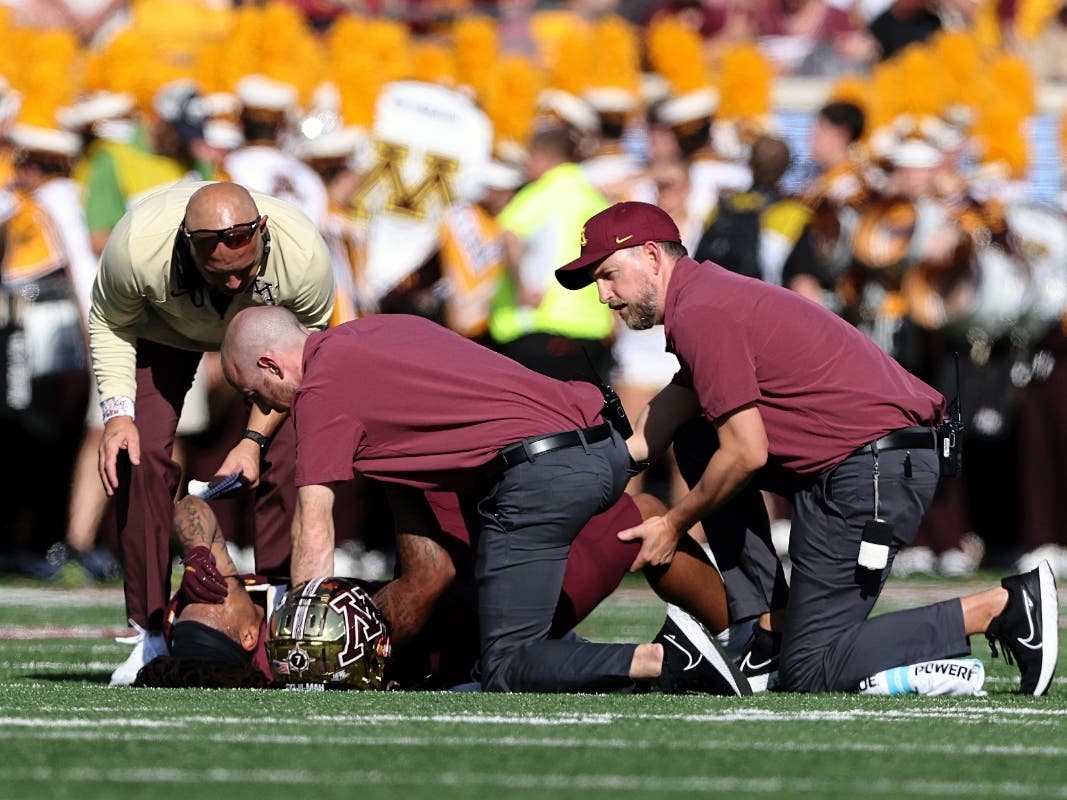 Minnesota wide receiver Chris Autman-Bell is checked on by athletic trainers and head coach P.J. Fleck after a lower leg injury during the first half of an NCAA college football game against Colorado, Saturday, Sept. 17, 2022, in Minneapolis.