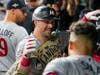 Minnesota Twins' Kyle Farmer celebrates in the dugout after his two-run home run against the Houston Astros during the second inning in Game 2 of an American League Division Series baseball game in Houston, Sunday, Oct. 8, 2023.